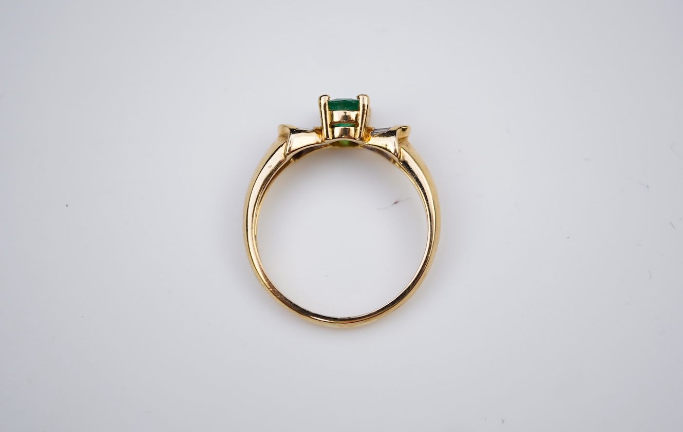 An emerald and diamond ring